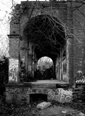 A dark, monochrome photograph depicting the entrance hall of a building. The second image in the "Places That Time Forgott" series, titled "Passage-to-the-Past".